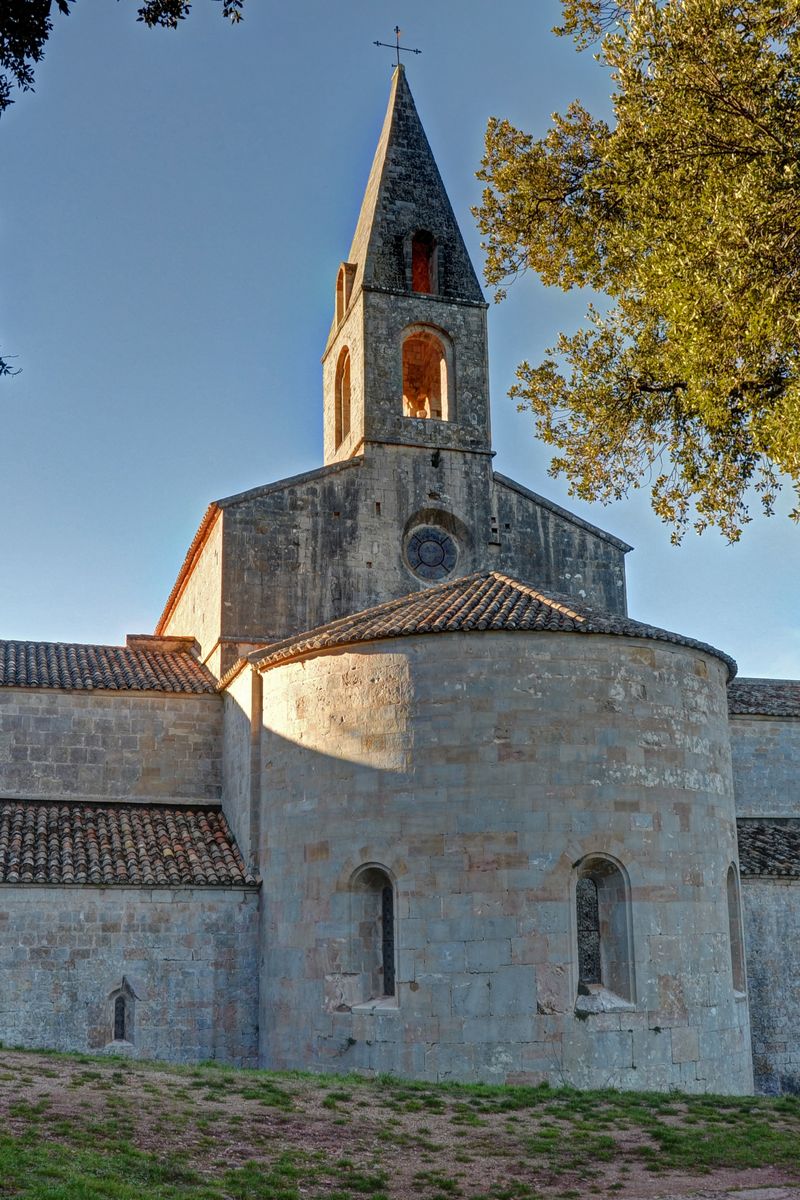 The pale limestone cloister and church of Thoronet Abbey in the Provençal countryside, Var, France